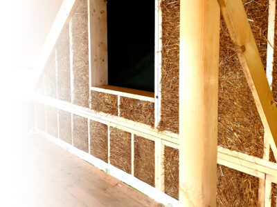 Interior view of a timber building with a straw wall, made from DD24 modules with gable cut from LORENZ